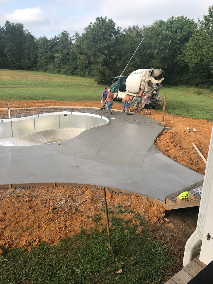 Inspiration for a mid-sized timeless backyard concrete and kidney-shaped lap pool remodel