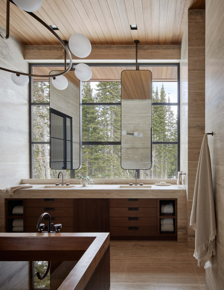 Exempel på ett mycket stort modernt beige beige en-suite badrum, med släta luckor, bruna skåp, ett fristående badkar, en dusch i en alkov, beige kakel, stenhäll, beige väggar, marmorgolv, ett integrerad handfat, bänkskiva i kvartsit, beiget golv och dusch med gångjärnsdörr
