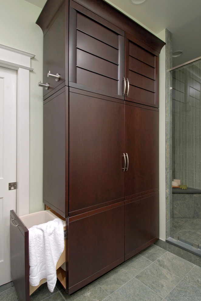 Inspiration for a mid-sized traditional master bathroom in DC Metro with shaker cabinets, brown cabinets, an alcove shower, a one-piece toilet, blue tile, glass tile, porcelain floors, a vessel sink, grey floor and a hinged shower door.