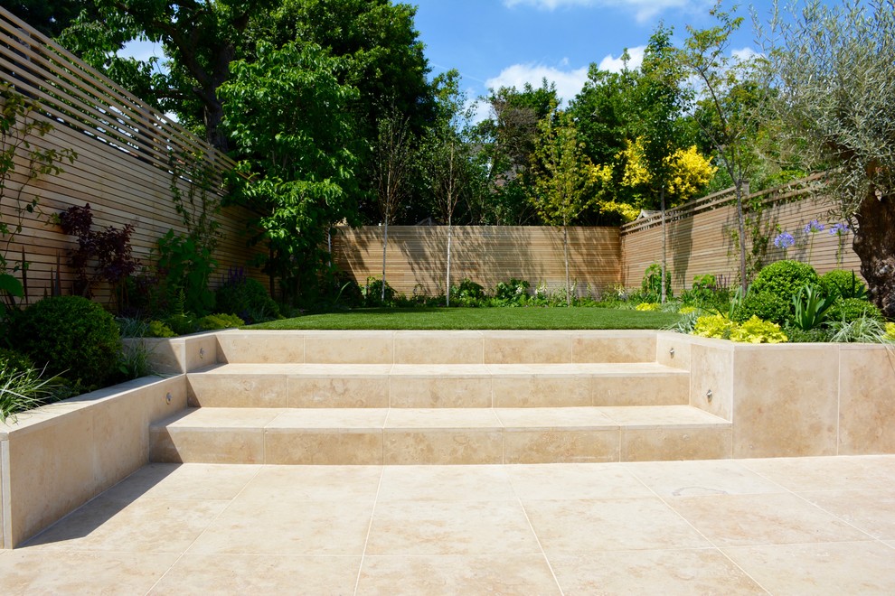 Inspiration for a medium sized contemporary back full sun garden for summer in London with natural stone paving.