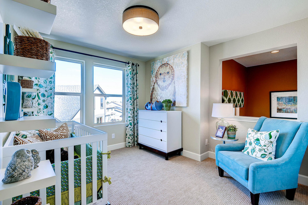This is an example of a transitional nursery for boys in Denver with grey walls, carpet and beige floor.