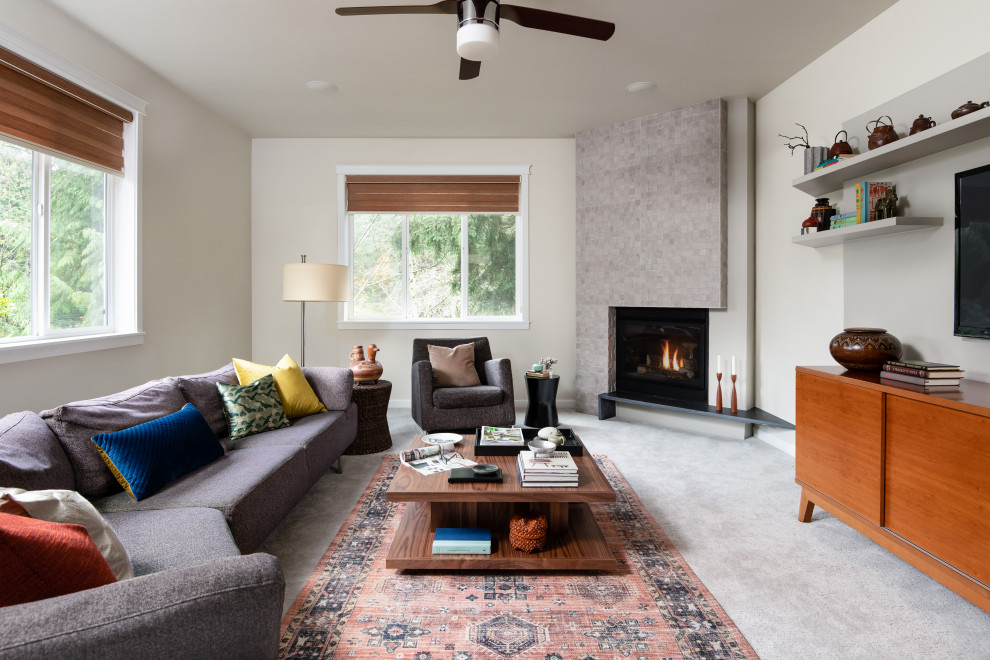 Inspiration for a mid-sized contemporary open concept living room in Seattle with white walls, carpet, a corner fireplace, a tile fireplace surround, a wall-mounted tv and grey floor.