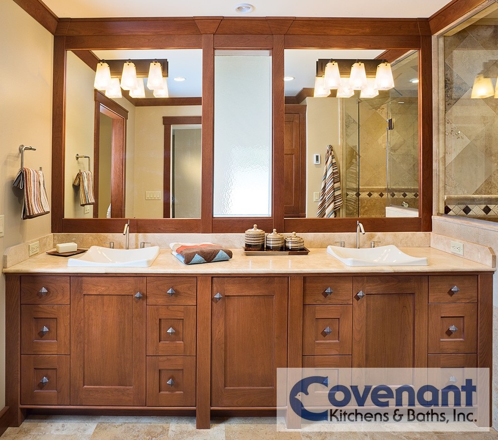 Inspiration for an arts and crafts bathroom in Other with a vessel sink, shaker cabinets, medium wood cabinets, limestone benchtops, an alcove shower, beige tile, stone tile, beige walls and travertine floors.