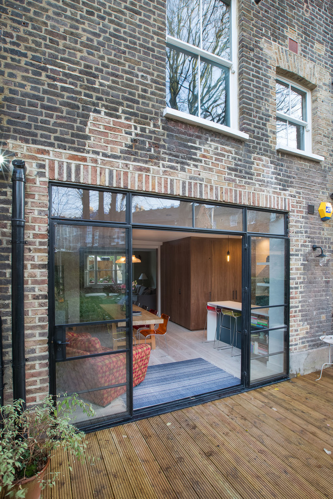 Photo of a large eclectic two-storey brick townhouse exterior in London.