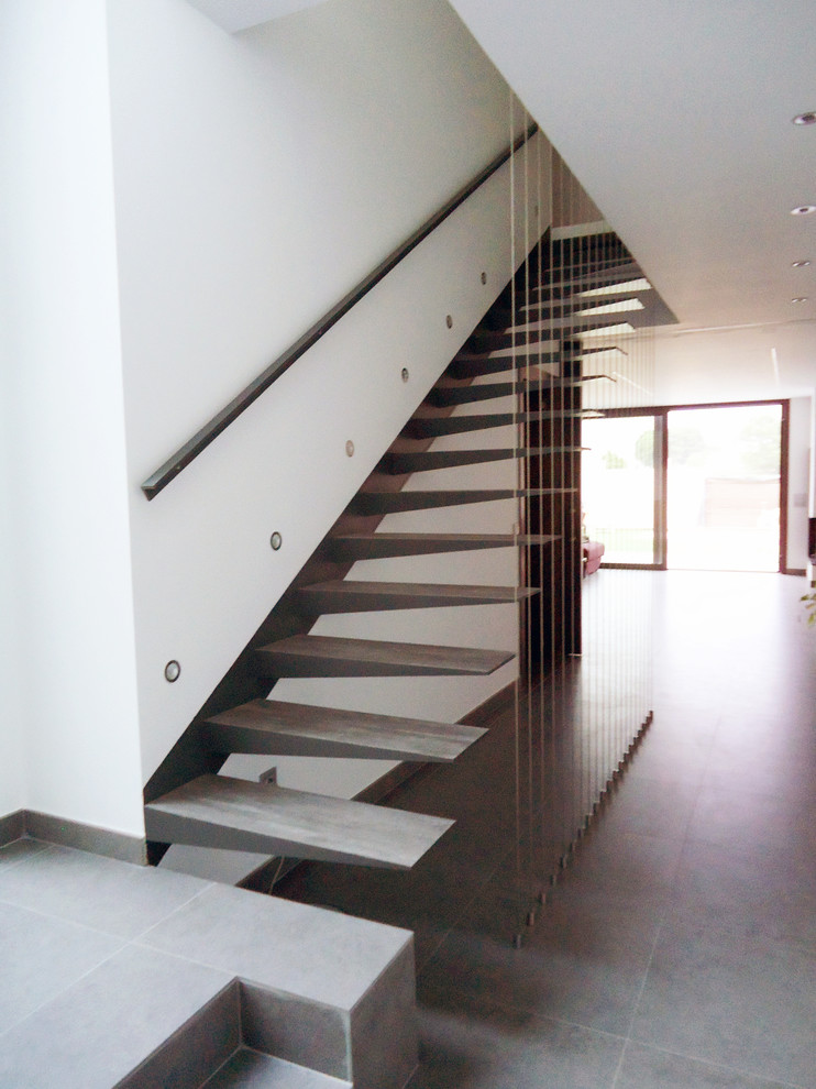 Design ideas for a mid-sized contemporary wood straight staircase in Other with open risers.