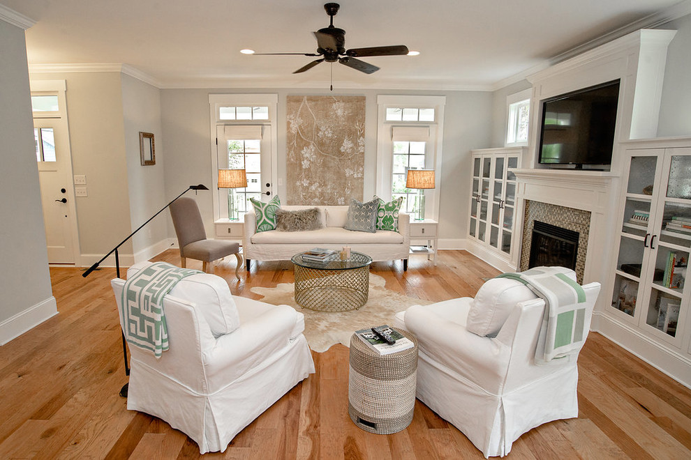 Photo of a large arts and crafts open concept living room in Wilmington with light hardwood floors, a standard fireplace, a tile fireplace surround and a wall-mounted tv.