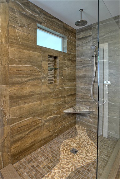 Photo of a large transitional master bathroom in Seattle with a freestanding tub, an open shower, brown tile, grey walls, pebble tile floors, an undermount sink and porcelain tile.