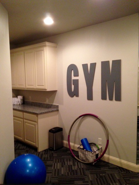 Large transitional multipurpose gym in Dallas with beige walls and carpet.