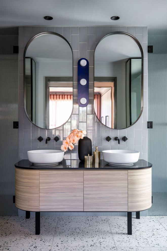 Medium sized contemporary ensuite bathroom in Sydney with recessed-panel cabinets, light wood cabinets, granite worktops, black worktops, double sinks and a freestanding vanity unit.