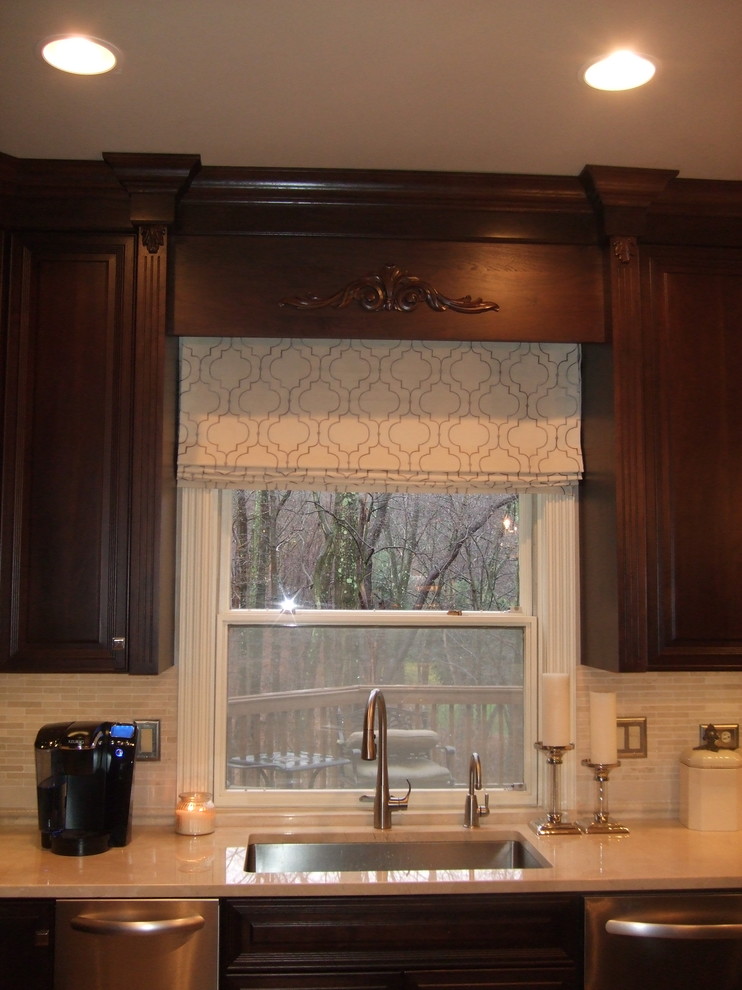 Kitchen - large transitional kitchen idea with a single-bowl sink, raised-panel cabinets, dark wood cabinets, marble countertops, stainless steel appliances and an island