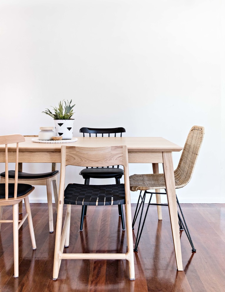 Photo of a beach style dining room in Wollongong with white walls, medium hardwood floors and brown floor.