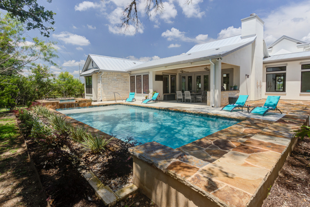 Mid-sized transitional backyard rectangular natural hot tub photo in Austin with decking