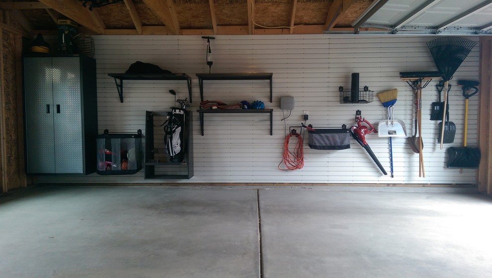 This is an example of a mid-sized transitional attached two-car workshop in Denver.