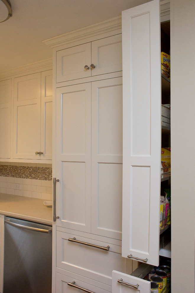 Eat-in kitchen - small transitional u-shaped dark wood floor and brown floor eat-in kitchen idea in Raleigh with an undermount sink, recessed-panel cabinets, white cabinets, quartz countertops, white backsplash, subway tile backsplash, stainless steel appliances, no island and beige countertops