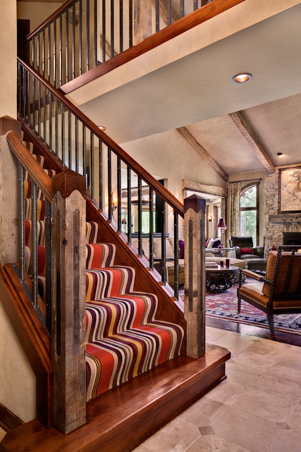 Design ideas for a large traditional carpeted straight staircase in Milwaukee with wood risers and wood railing.