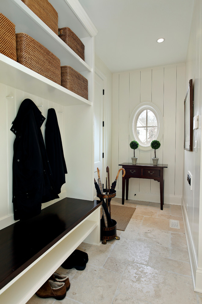 Design ideas for a traditional mudroom in Chicago with beige walls and travertine floors.