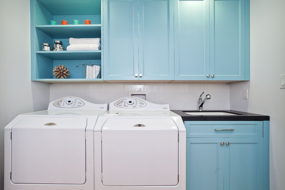 Photo of a beach style laundry room in San Francisco with white walls and a side-by-side washer and dryer.