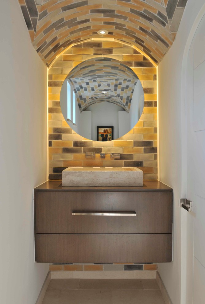 This is an example of a mediterranean powder room in Dallas with a vessel sink, flat-panel cabinets, dark wood cabinets, multi-coloured tile and subway tile.