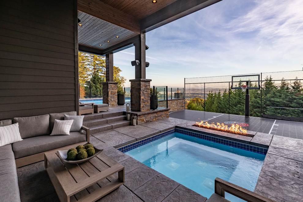 Inspiration for a country pool in Portland with a hot tub.