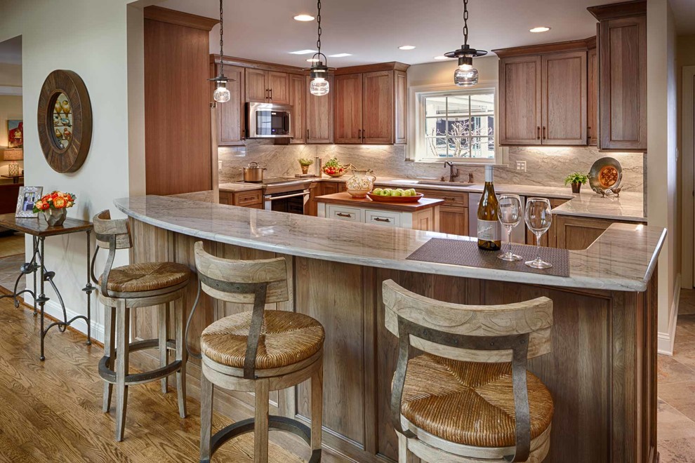 Example of an u-shaped porcelain tile kitchen design in DC Metro with quartzite countertops and an island