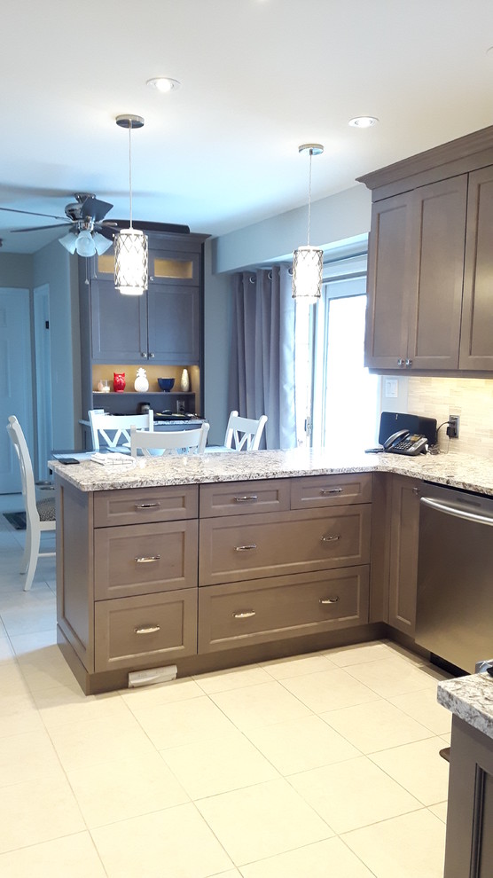 Eat-in kitchen - mid-sized transitional u-shaped porcelain tile eat-in kitchen idea in Toronto with an undermount sink, shaker cabinets, gray cabinets, granite countertops, gray backsplash, stainless steel appliances and a peninsula