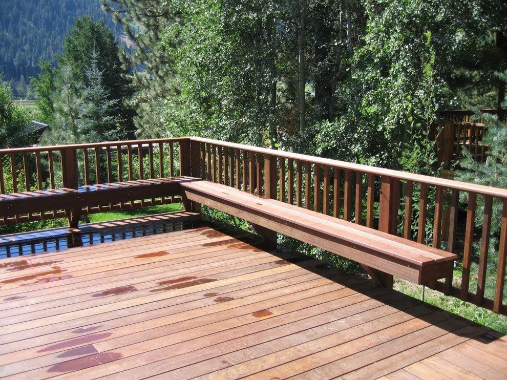 Example of a large mountain style backyard deck design in Sacramento with no cover