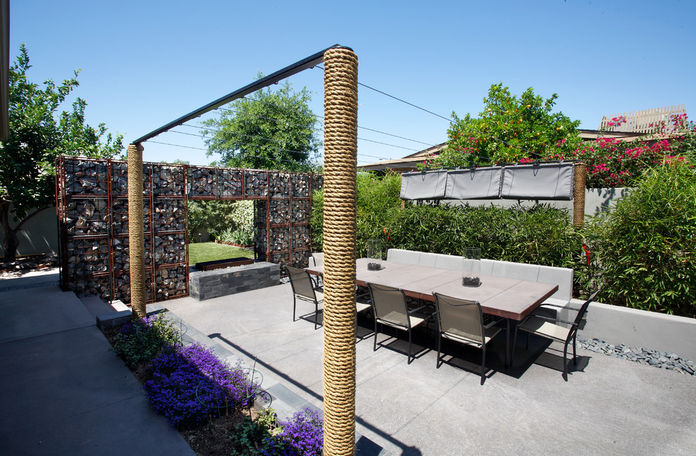 Design ideas for a mid-sized industrial backyard patio in Phoenix.