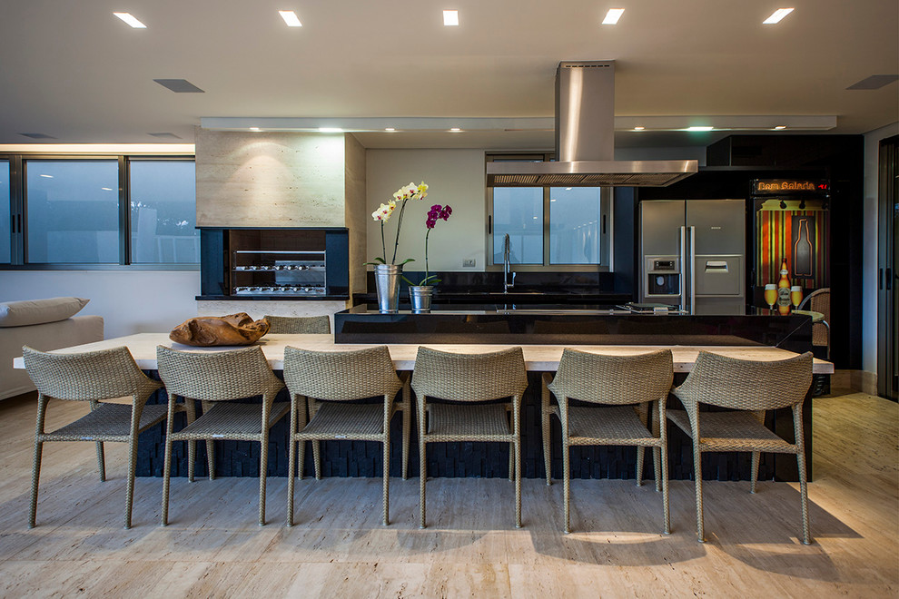 Design ideas for a mid-sized contemporary galley eat-in kitchen in Other with flat-panel cabinets, black cabinets, solid surface benchtops, black splashback, stone slab splashback, stainless steel appliances, marble floors, with island and beige floor.