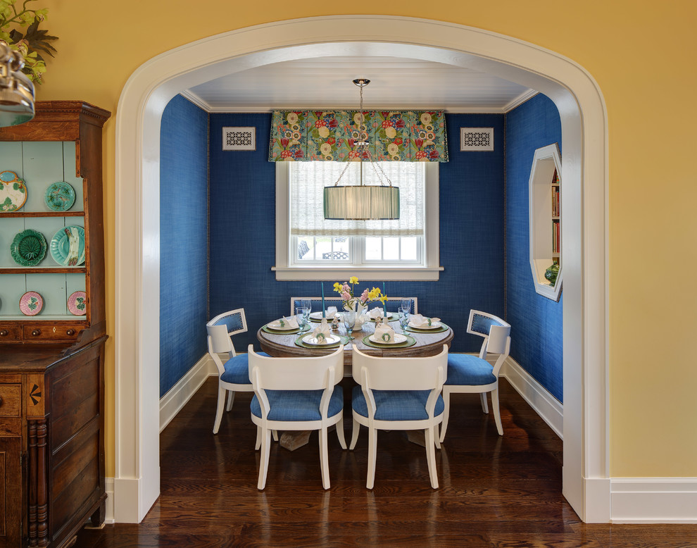 Photo of a traditional separate dining room in Chicago with blue walls, dark hardwood floors, no fireplace and brown floor.