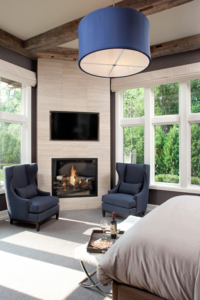 Design ideas for a transitional master bedroom in Minneapolis with grey walls, carpet, a corner fireplace and a tile fireplace surround.