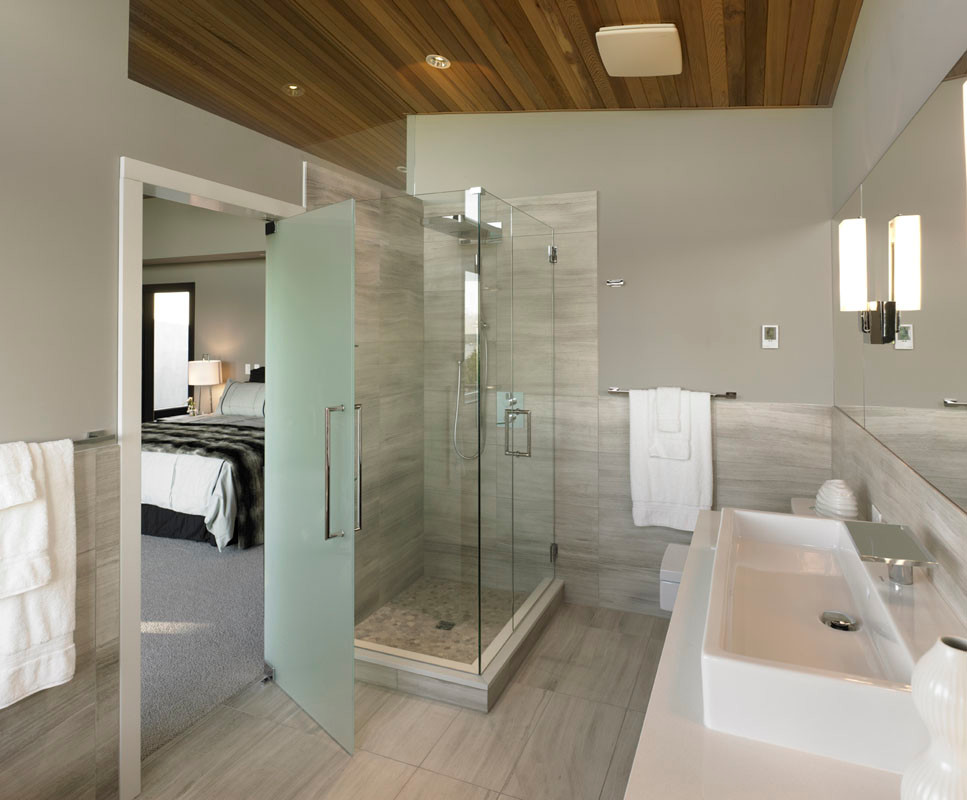 Photo of a modern bathroom in Vancouver with a vessel sink, engineered quartz benchtops, a corner shower, multi-coloured tile, stone slab and a one-piece toilet.