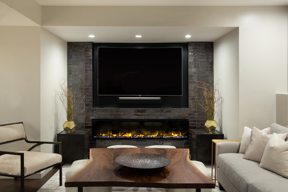 This is an example of a large transitional fully buried basement in Other with multi-coloured walls, dark hardwood floors, a tile fireplace surround, brown floor and a ribbon fireplace.