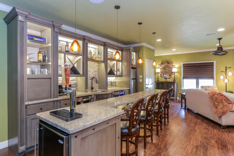 This is an example of a small eclectic single-wall open plan kitchen in Houston with an undermount sink, open cabinets, distressed cabinets, granite benchtops, grey splashback, stone tile splashback, stainless steel appliances, medium hardwood floors and with island.