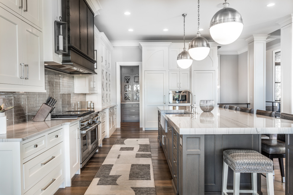 Transitional l-shaped kitchen photo with flat-panel cabinets and an island
