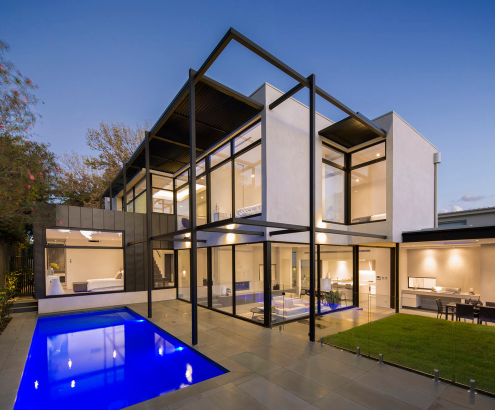 This is an example of a large contemporary two-storey exterior in Melbourne with a flat roof.