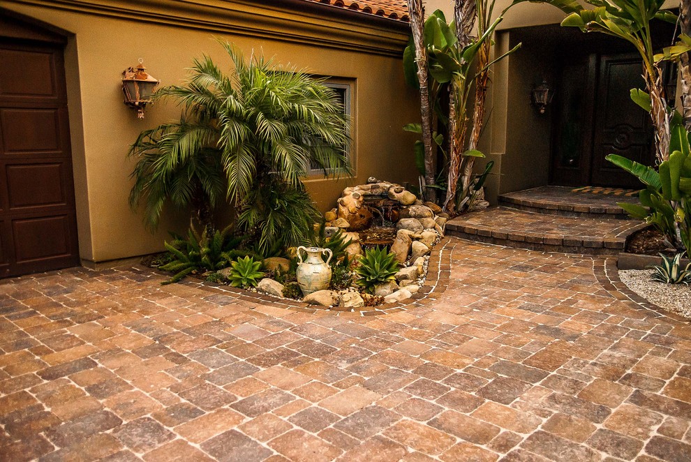 Inspiration for a large mediterranean front yard patio in Los Angeles with concrete pavers.