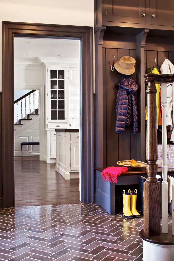 Inspiration for a traditional mudroom in New York with white walls.