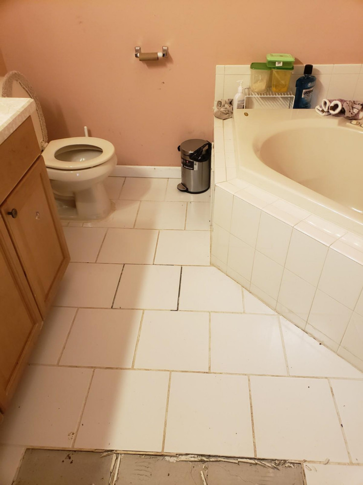 Bathroom - mid-sized traditional master pink tile single-sink bathroom idea in New York with furniture-like cabinets, beige cabinets, a hot tub, a wall-mount sink, granite countertops, beige countertops and a freestanding vanity