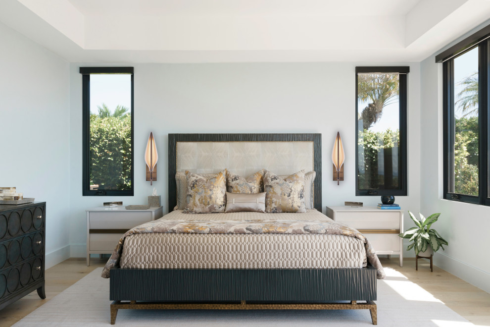 This is an example of a contemporary bedroom in Los Angeles with grey walls, light hardwood floors and beige floor.