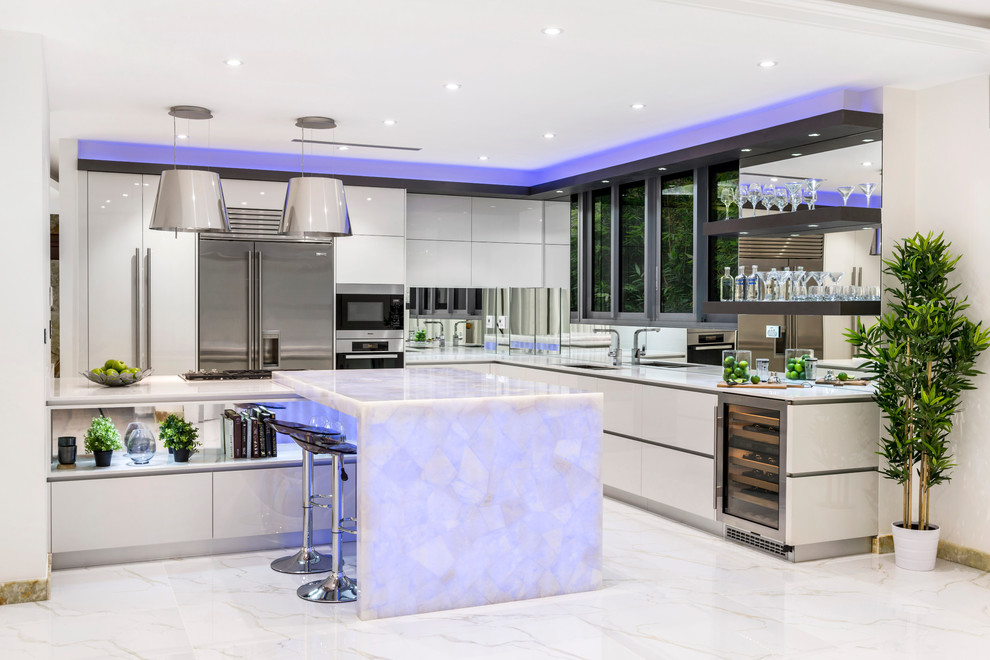 Design ideas for a contemporary l-shaped eat-in kitchen in Brisbane with an undermount sink, flat-panel cabinets, white cabinets, quartz benchtops, metallic splashback, mirror splashback, stainless steel appliances, marble floors and with island.