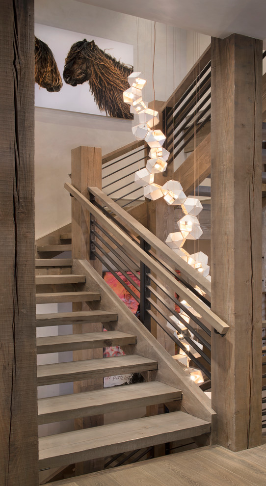 Inspiration for a country wood u-shaped staircase in New York with open risers and cable railing.