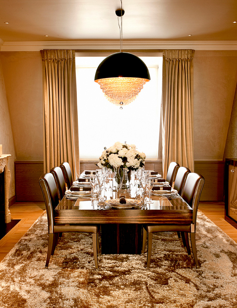 Design ideas for a contemporary dining room in London with beige walls and light hardwood floors.