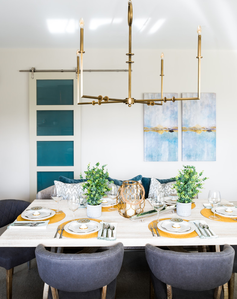 Example of a mid-sized transitional porcelain tile and gray floor kitchen/dining room combo design in Phoenix with white walls, a standard fireplace and a brick fireplace