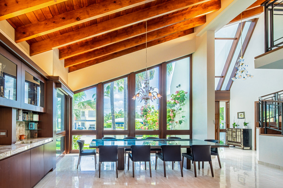 Inspiration for a modern open plan dining in Miami with white walls, marble floors, white floor and exposed beam.