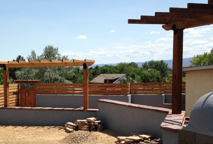 Photo of a mid-sized rustic full sun backyard landscaping in Denver with a fire pit for summer.