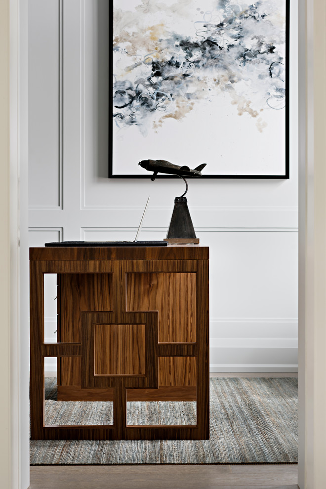 Inspiration for a mid-sized traditional study room in Toronto with grey walls, medium hardwood floors, a freestanding desk and brown floor.