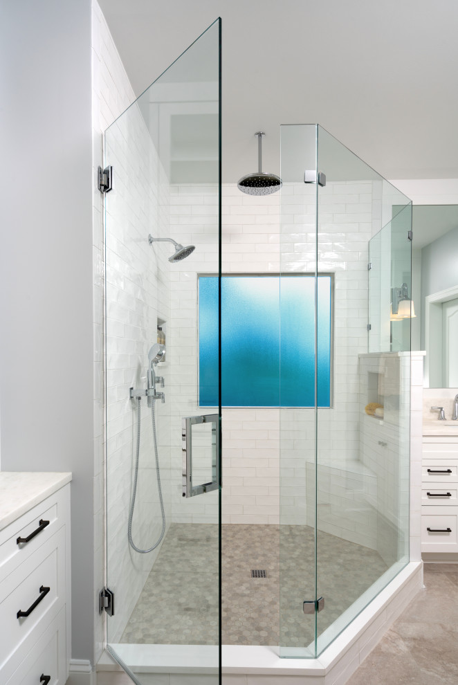 Inspiration for a mid-sized transitional master bathroom in Charlotte with shaker cabinets, white cabinets, a corner shower, a two-piece toilet, white tile, ceramic tile, blue walls, porcelain floors, an undermount sink, marble benchtops, beige floor, a hinged shower door, white benchtops, a niche, a double vanity and a built-in vanity.
