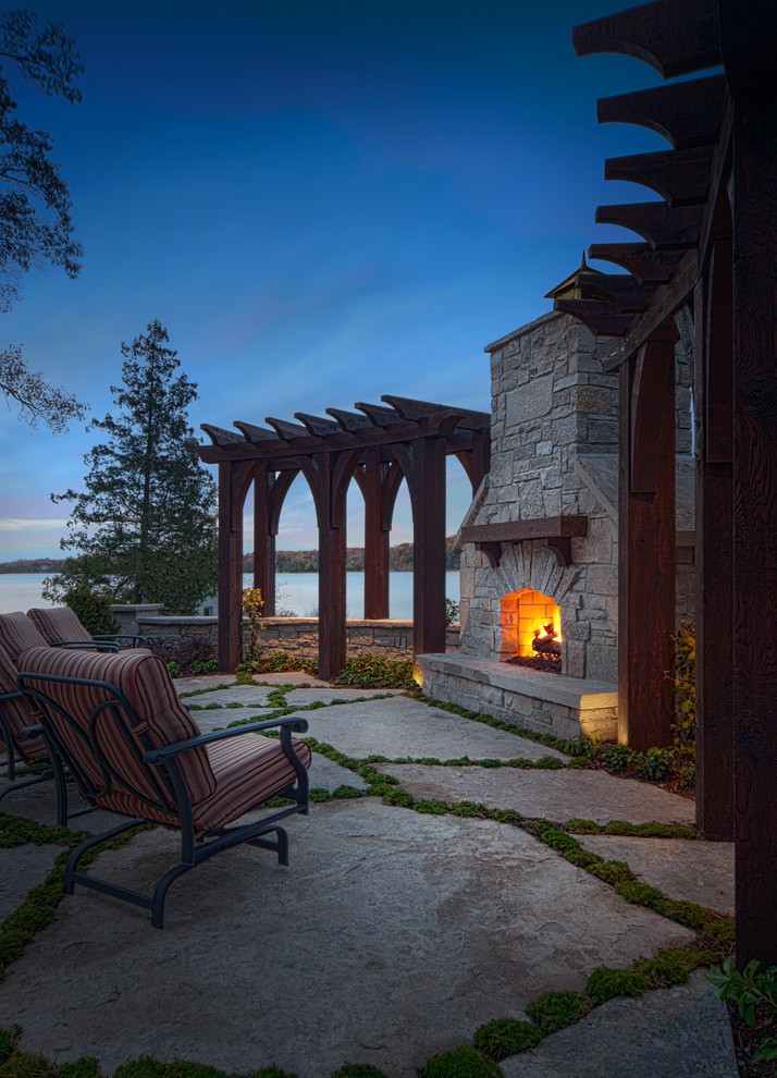 Inspiration for a mediterranean patio in Detroit with natural stone pavers and a fire feature.