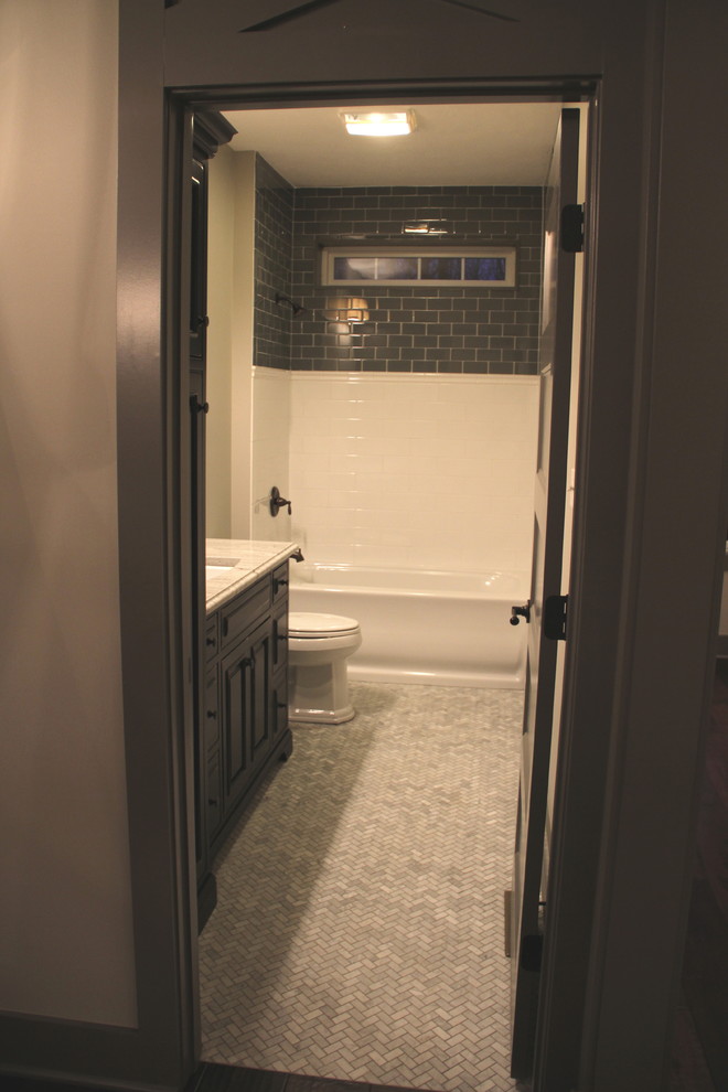 Drop-in bathtub - large rustic 3/4 multicolored tile and ceramic tile cement tile floor and gray floor drop-in bathtub idea with black cabinets, a two-piece toilet, beige walls, an undermount sink, granite countertops, raised-panel cabinets and a hinged shower door