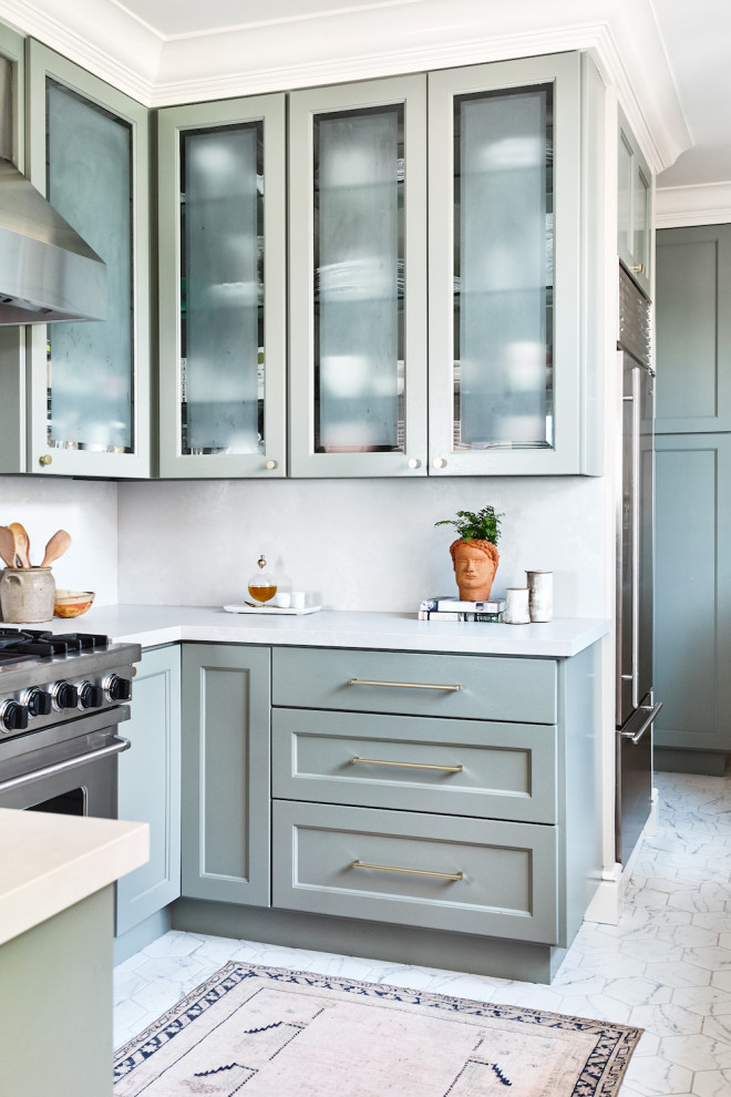 This is an example of a transitional u-shaped kitchen in San Francisco with shaker cabinets, grey cabinets, white splashback, stainless steel appliances, white floor and white benchtop.